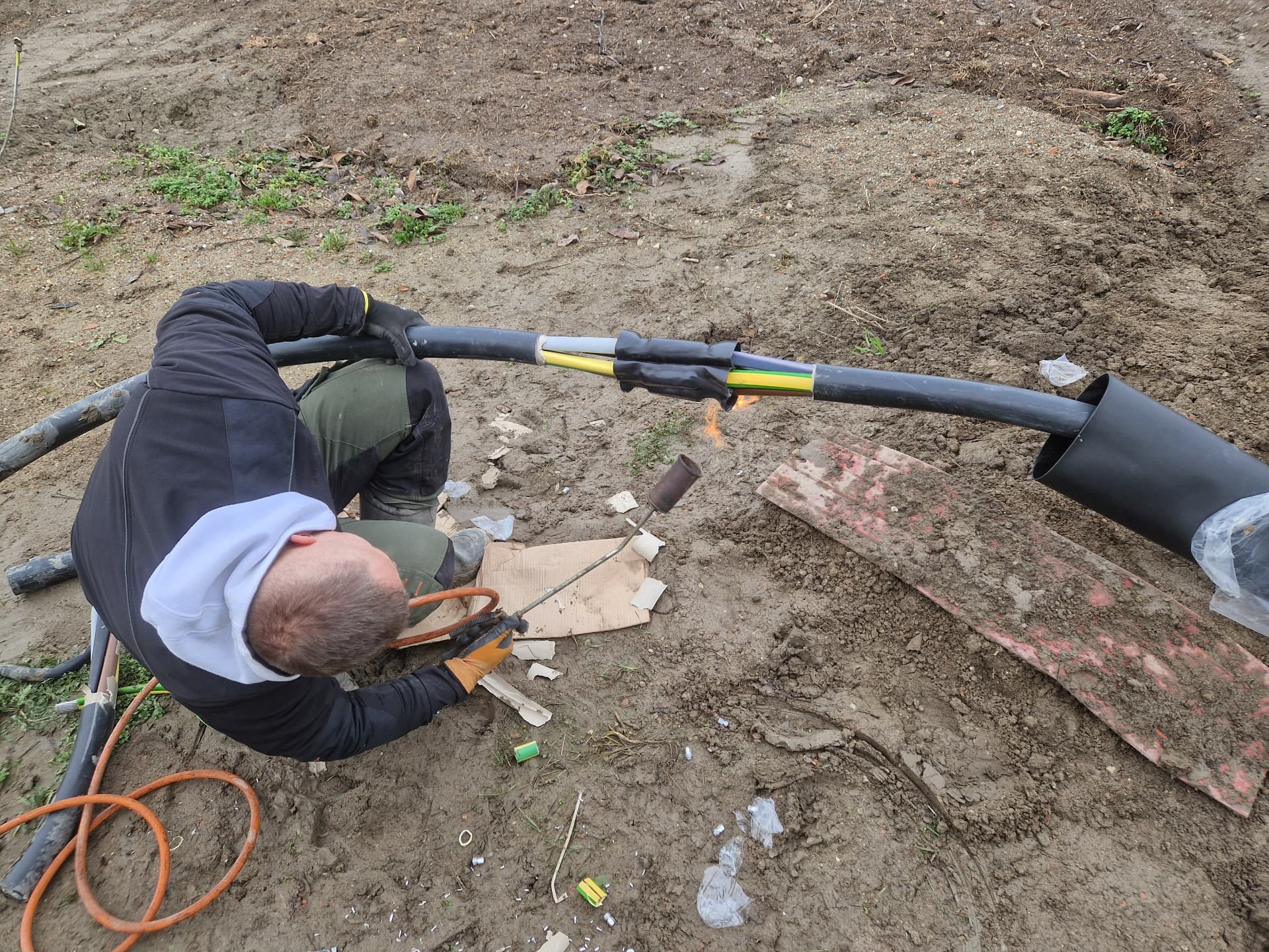 Technik vyhotovuje káblovú spojku na zemnom kábli